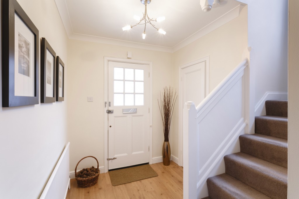 Interior of a white mudroom and carpeted stairs