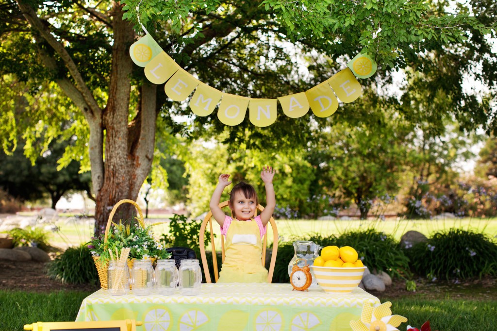 Little Girl At The Lemonade Stand Raising Hands