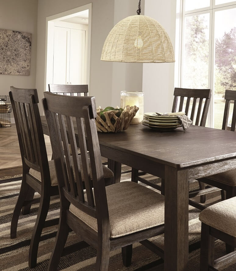 grayish brown table and chairs with cream cushioned seats